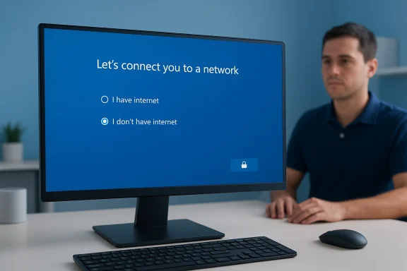 A man sits at a desk as the monitor prompts to connect to a network with internet options.