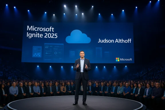 A speaker presents on stage at Microsoft Ignite 2025 beneath a large blue screen with a cloud icon. A speaker presents on stage at Microsoft Ignite 2025 beneath a large blue screen with a cloud icon.