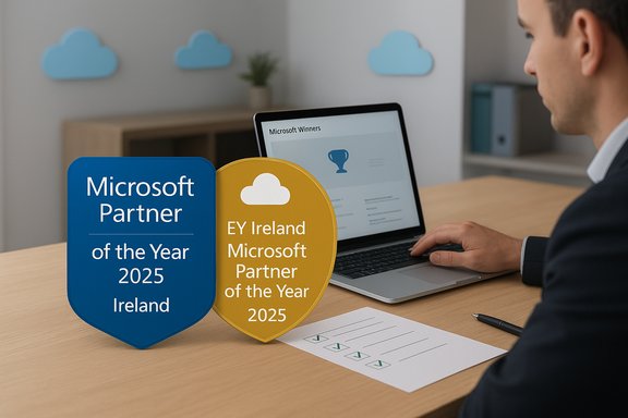 Two awards for Microsoft Partner of the Year 2025 Ireland on a desk beside a laptop.