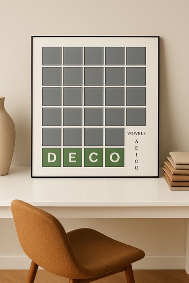 A framed poster of gray grid squares with four green letters spelling DECO on a desk.