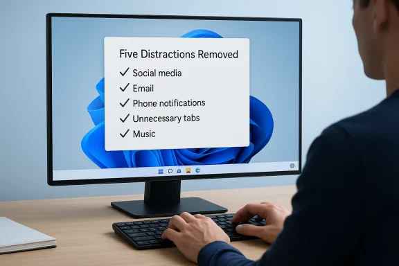 Person focuses on a computer screen displaying a “Five Distractions Removed” checklist.