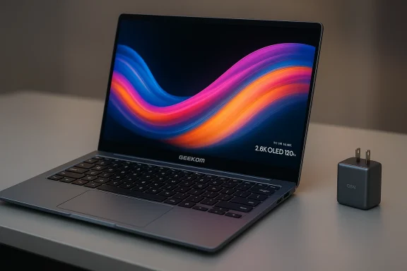 A Geekom laptop on a desk shows a vivid, colorful wave wallpaper, with a small charger beside it.
